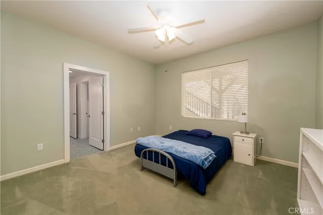 a spacious bedroom with a bed and a chandelier