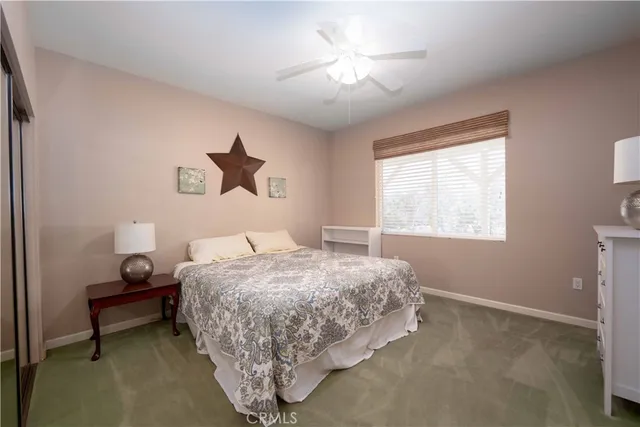a bedroom with bed and a chandelier