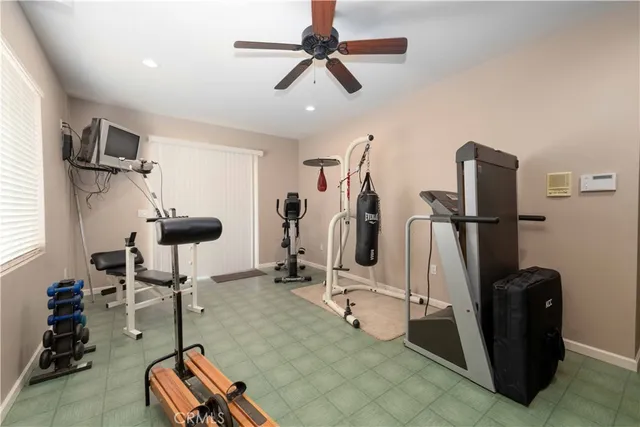 a room with gym equipment and a view of living room