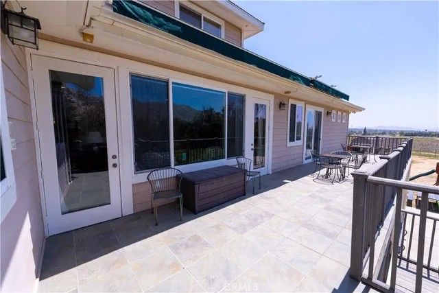a view of a patio with table and chairs
