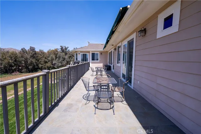a view of a house with a backyard porch and sitting area