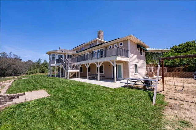 a view of a house with a yard and lake view