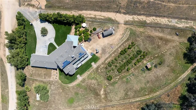 a view of a house with a yard and potted plants
