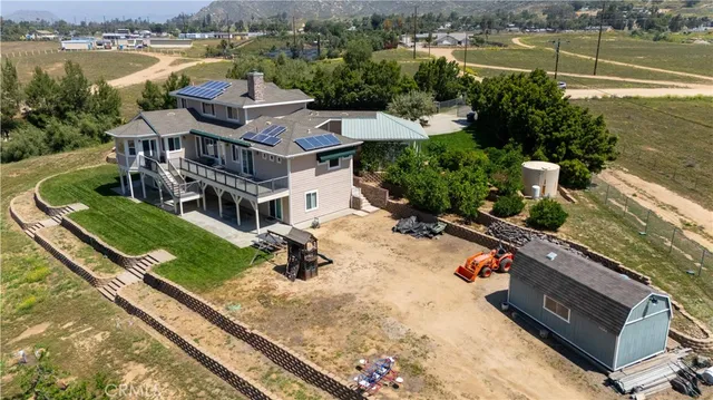 a view of a patio with chairs and potted plants