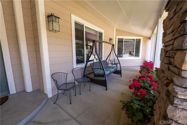 a building outdoor space with patio furniture and garden