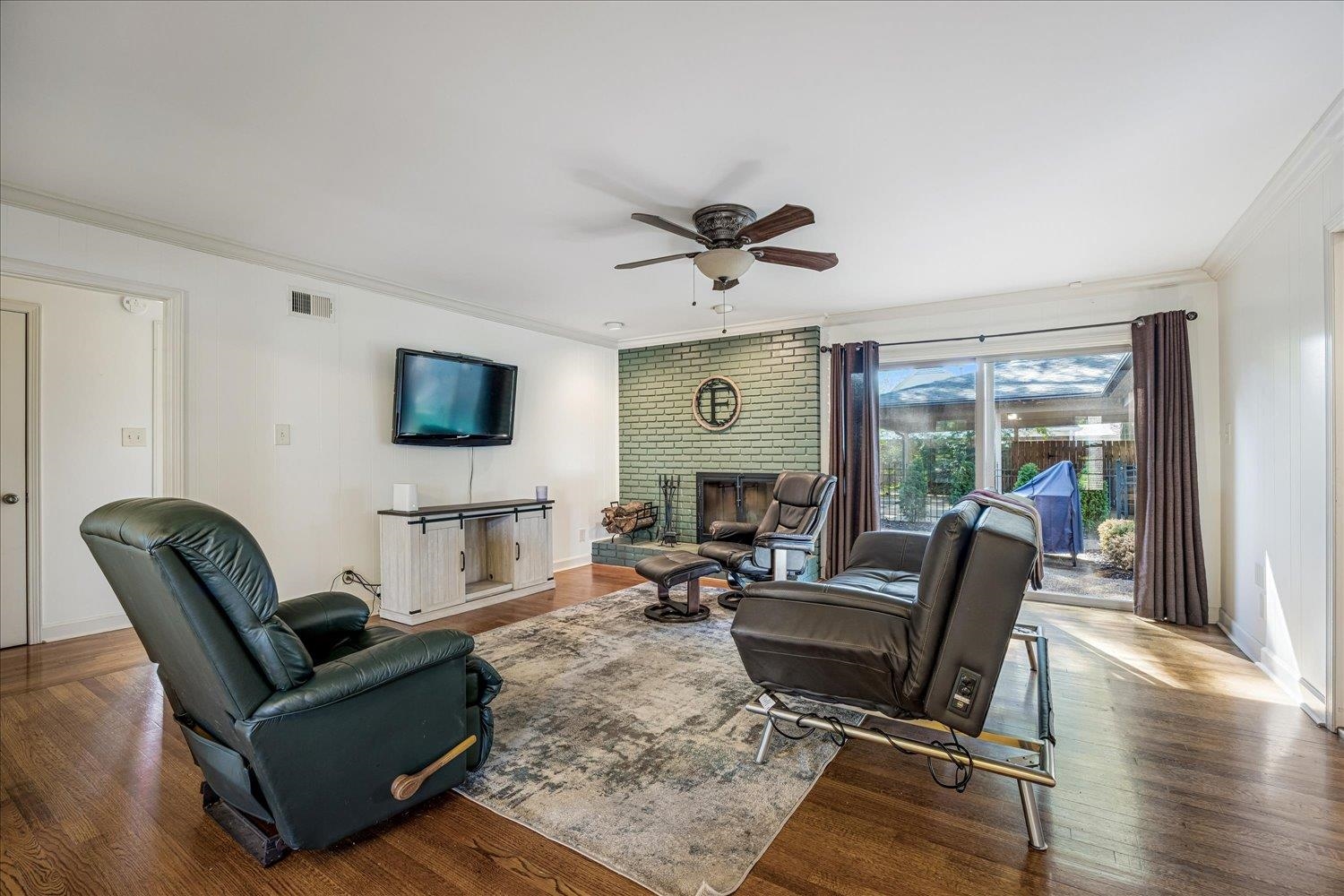 5323 Dee Road Memphis, TN 38117 - Photo 16 of 40 a living room with furniture a flat screen tv and a floor to ceiling window