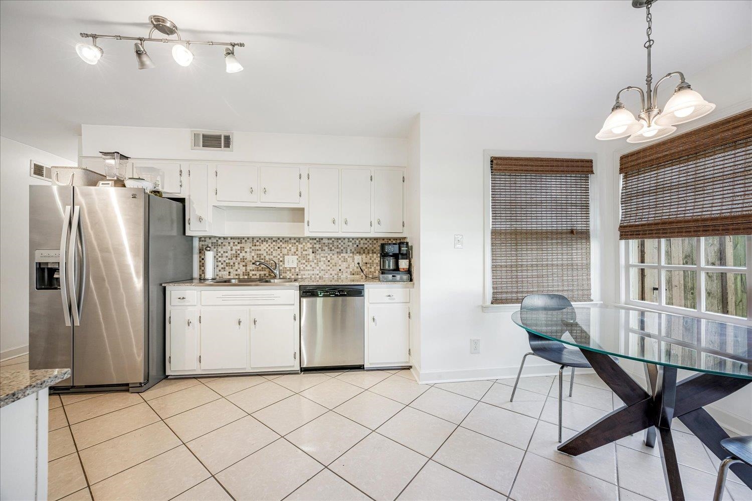 5323 Dee Road Memphis, TN 38117 - Photo 18 of 40 a kitchen with stainless steel appliances kitchen island granite countertop a refrigerator and a stove top oven