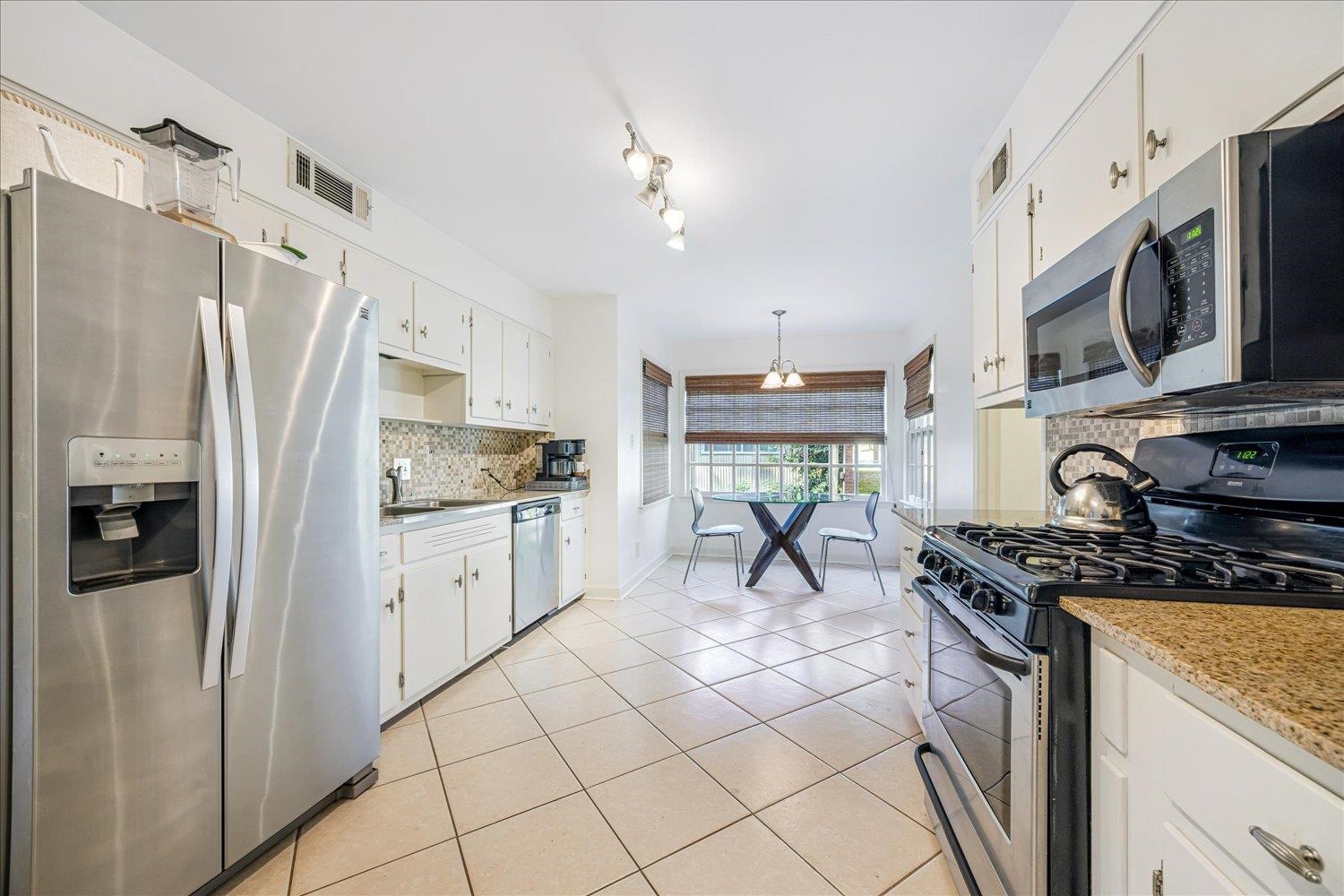 5323 Dee Road Memphis, TN 38117 - Photo 21 of 40 a kitchen with stainless steel appliances granite countertop a stove a sink and a refrigerator