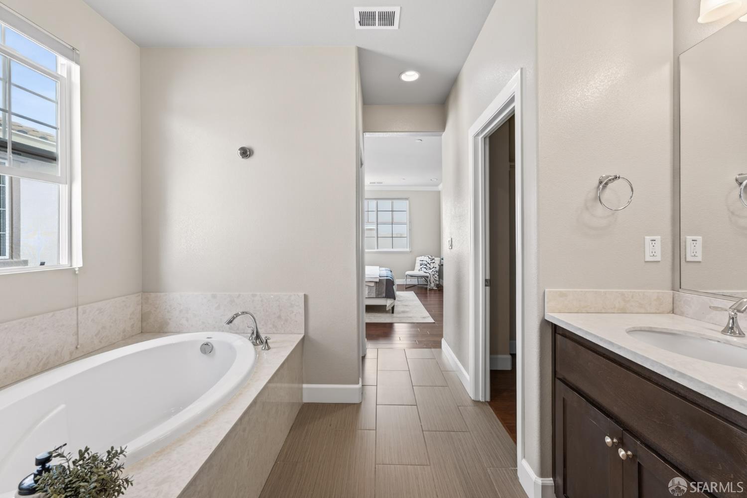 360 Gerald Circle Milpitas, CA 95035 - Photo 29 of 46 a bathroom with a tub a sink and a large mirror