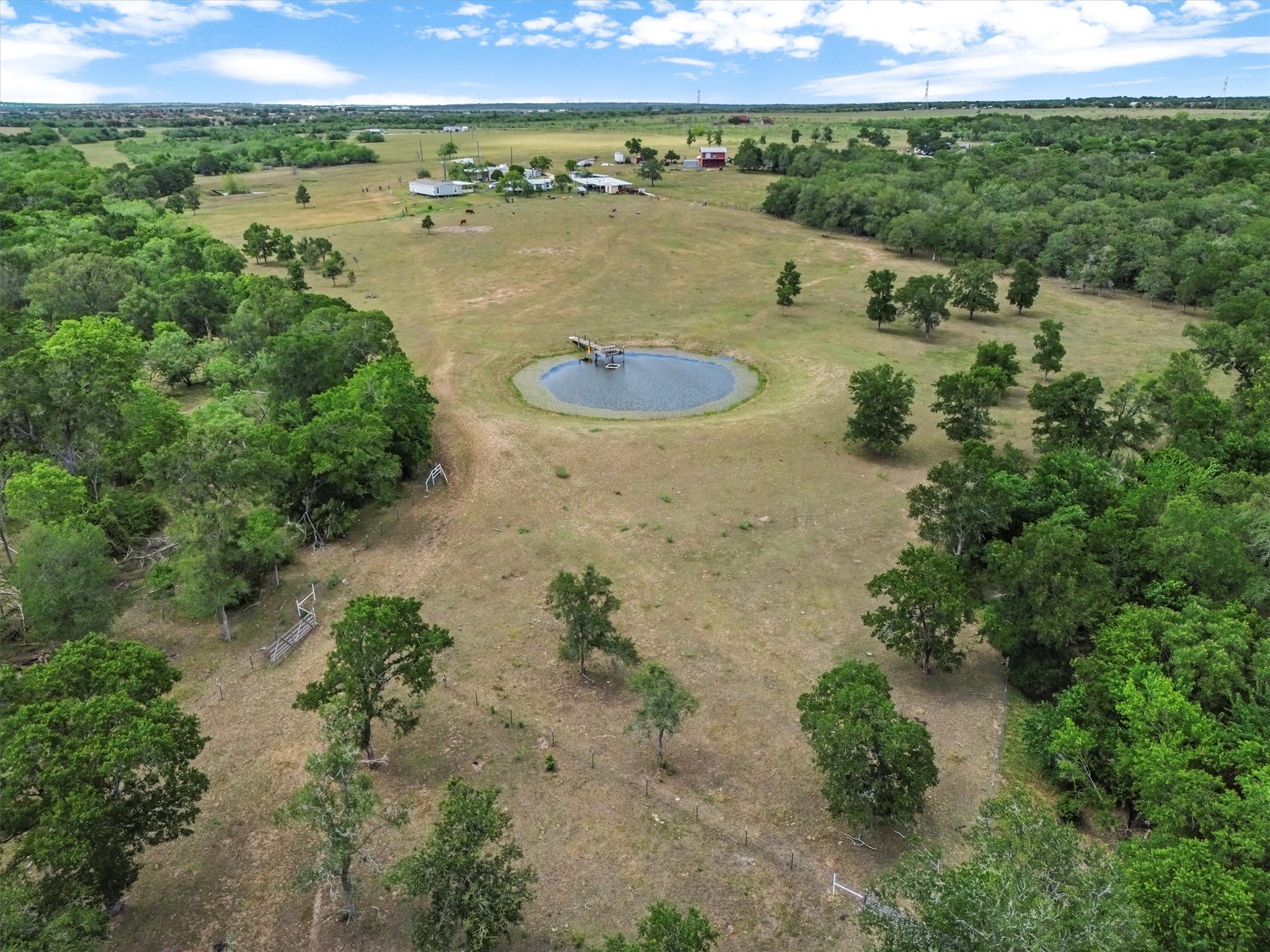 480 Grandpa Road Lockhart, TX 78644 - Photo 26 of 35 The property itself is a private
haven with a fishing pond, mature trees, cross-fencing for livestock, a corral, and wide-open skies that deliver
unforgettable sunsets.