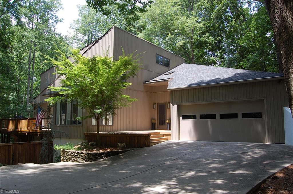 Owls Roost contemporary home on a 1.6 acre, pond-side wooded lot.  Convenient to parks, restaurants and shopping.           