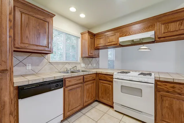a kitchen with a sink stove and cabinets