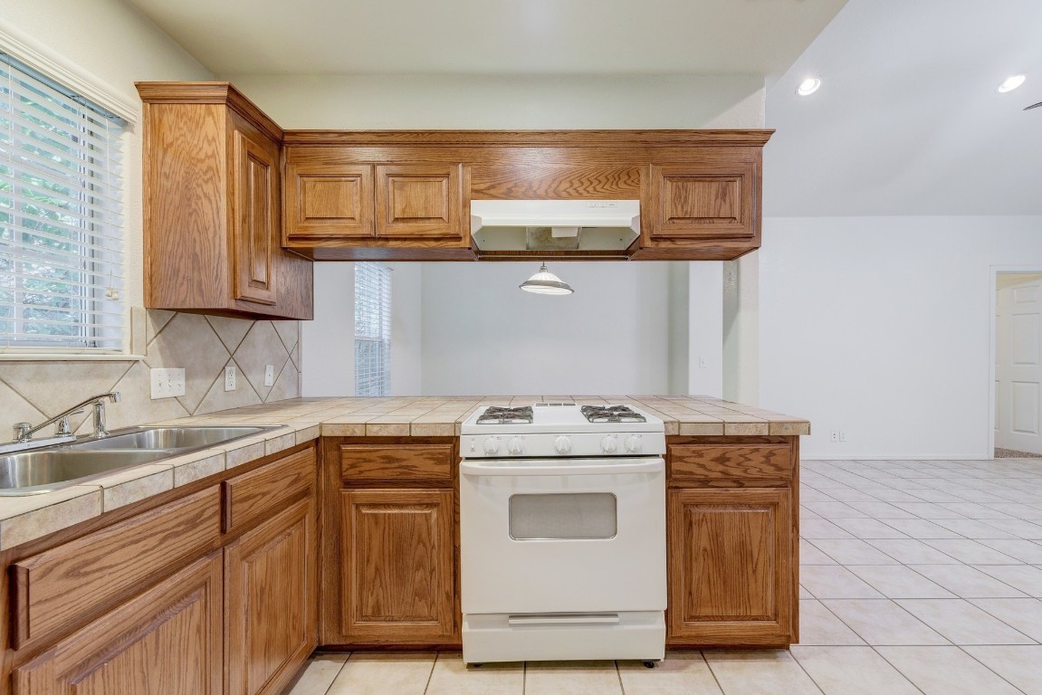 106 East 46th Street, Unit B Austin, TX 78751 - Photo 6 of 16 a kitchen with stainless steel appliances granite countertop a sink and cabinets with wooden floor