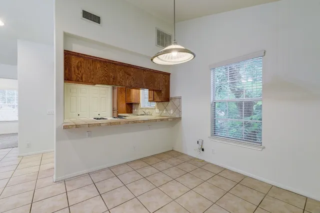 a kitchen with a sink cabinets and window