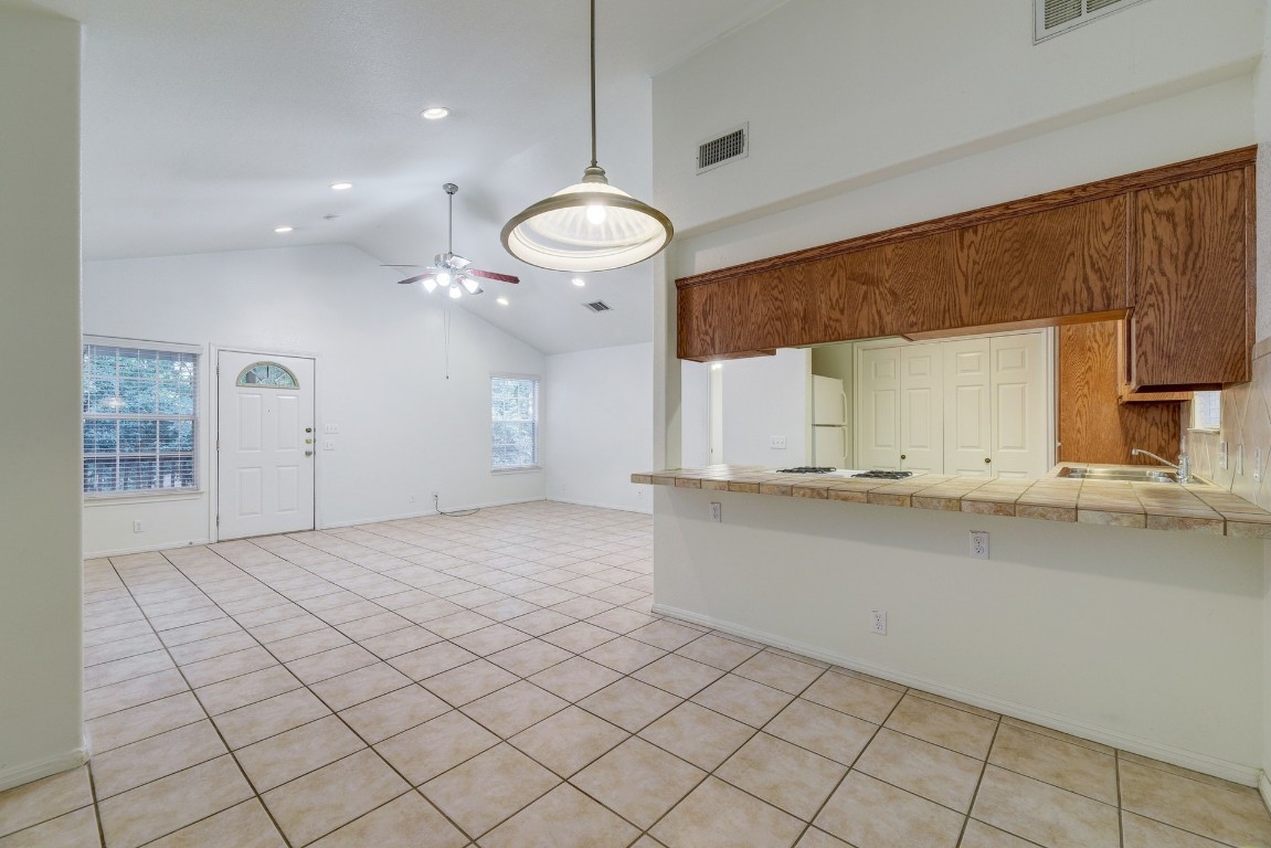 106 East 46th Street, Unit B Austin, TX 78751 - Photo 10 of 16 a view of a kitchen with kitchen island a sink stainless steel appliances and cabinets