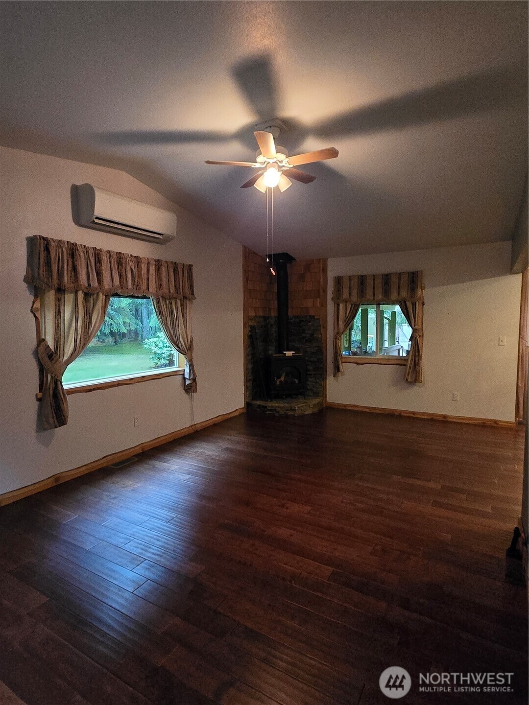 313 Minkler Road Winlock, WA 98596 - Photo 11 of 40 an empty room with wooden floor fan and windows