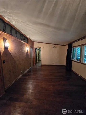 a view of wooden floor and windows in a room