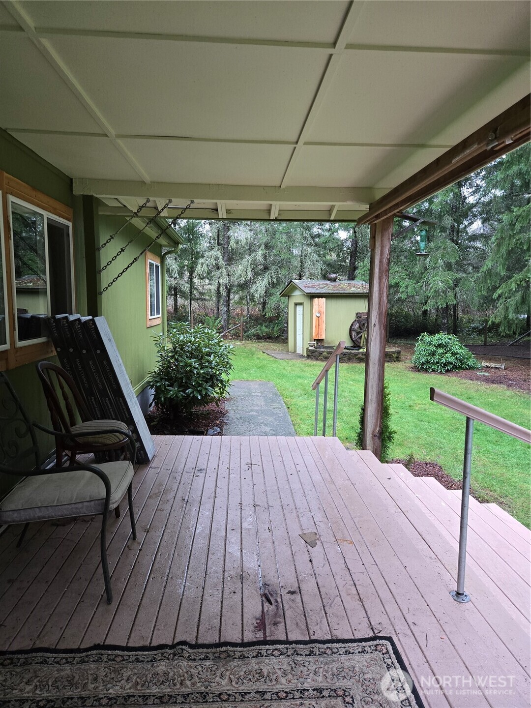 313 Minkler Road Winlock, WA 98596 - Photo 25 of 40 a view of a patio with table and chairs potted plants with wooden floor