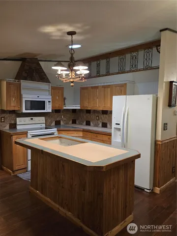 a kitchen with stainless steel appliances a refrigerator a stove a sink and a center island