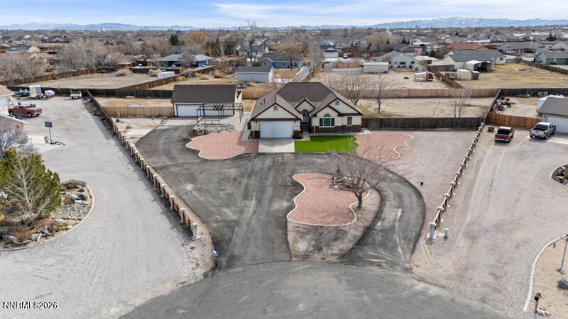 an aerial view of a house with a yard swimming pool and mountains