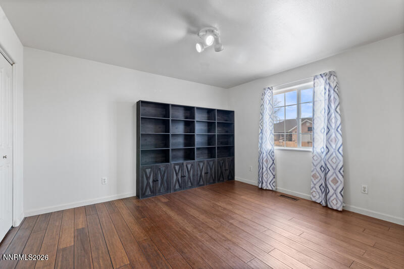 1060 Penelope Drive Fallon, NV 89406 - Photo 16 of 32 wooden floor in an empty room with a window