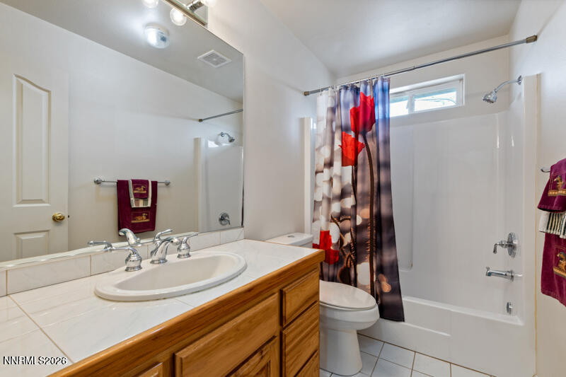1060 Penelope Drive Fallon, NV 89406 - Photo 20 of 32 a bathroom with a sink a toilet and shower curtain