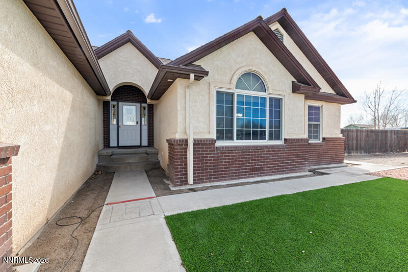 1060 Penelope Drive Fallon, NV 89406 - Photo 2 of 32 a front view of a house with a yard