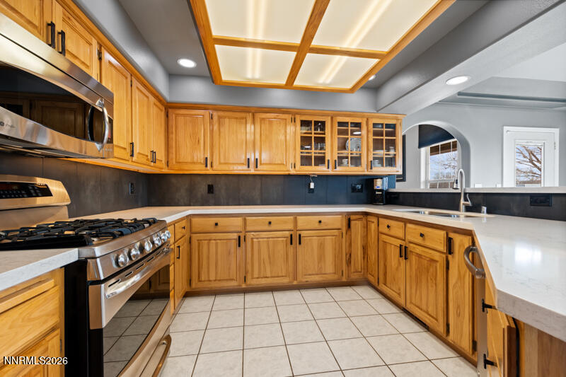 1060 Penelope Drive Fallon, NV 89406 - Photo 7 of 32 a kitchen with stainless steel appliances granite countertop a stove a sink and a microwave