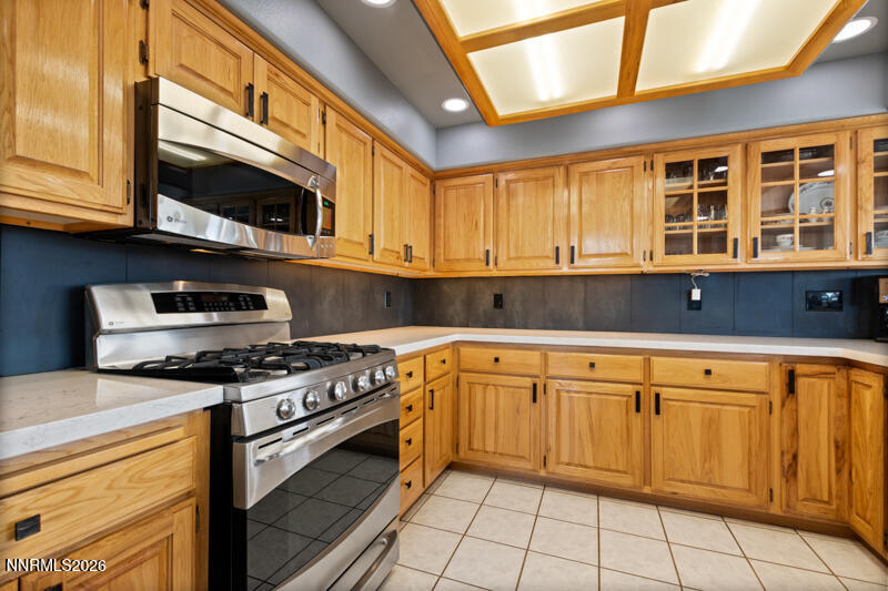 1060 Penelope Drive Fallon, NV 89406 - Photo 8 of 32 a kitchen with stainless steel appliances granite countertop a stove a sink and a microwave