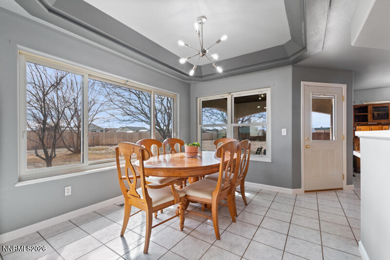 1060 Penelope Drive Fallon, NV 89406 - Photo 9 of 32 a dining room with furniture a chandelier and window