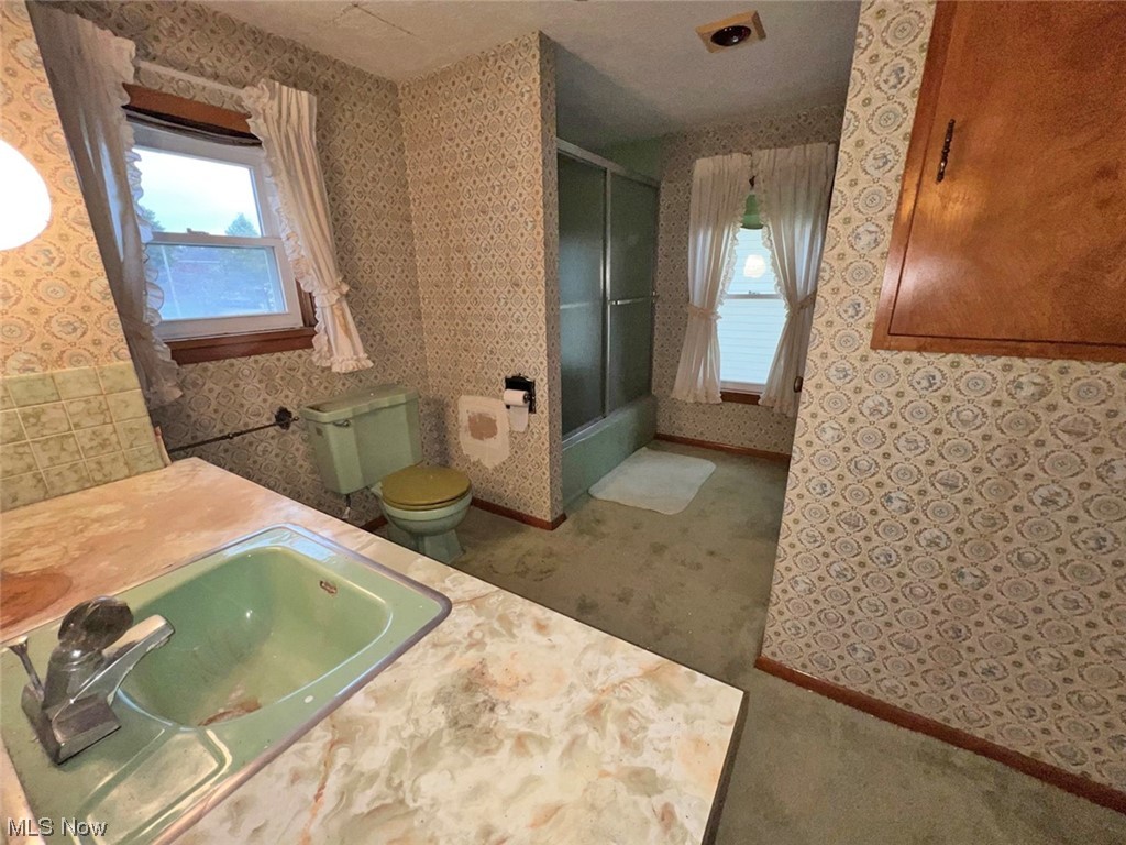 918 Amherst Road Northeast Massillon, OH 44646 - Photo 17 of 31 Bathroom featuring sink, an enclosed shower, and toilet