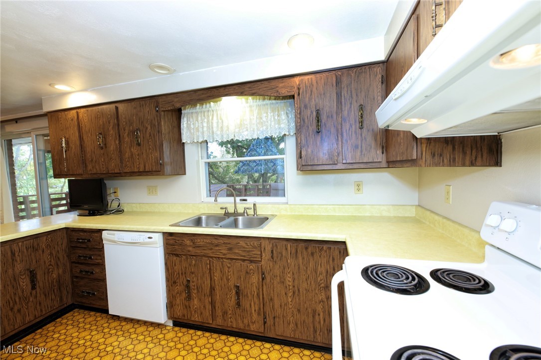 115 Carol Road Wellsburg, WV 26070 - Photo 13 of 36 Kitchen featuring white appliances, under cabinet range hood, light countertops, dark brown cabinets, and recessed lighting