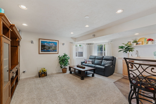 14883 Tooele Lane Draper, UT 84020 - Photo 35 of 49 Open-concept entertainment space featuring recessed lighting, light-toned carpeting, and a built-in media center