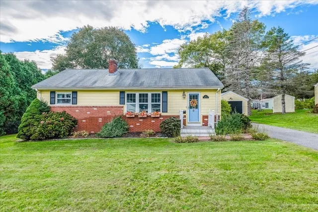 a front view of house with yard and green space
