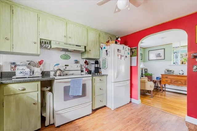 a kitchen with refrigerator and cabinets