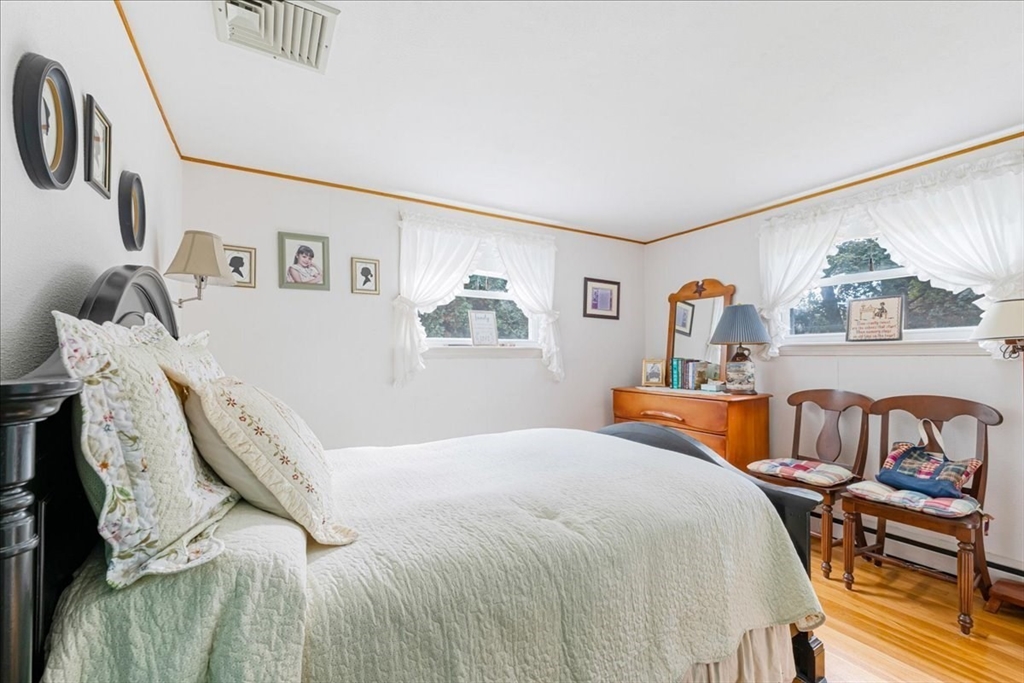 47 Beech Road Avon, MA 02322 - Photo 17 of 28 a bedroom with a bed and a table in it