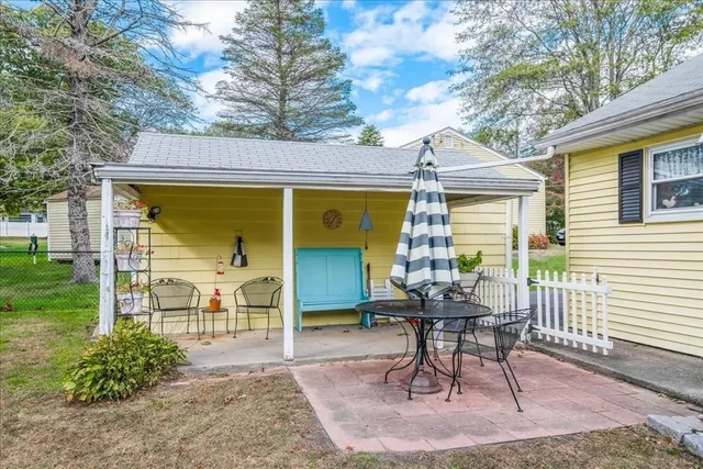 a view of a porch with furniture and garden