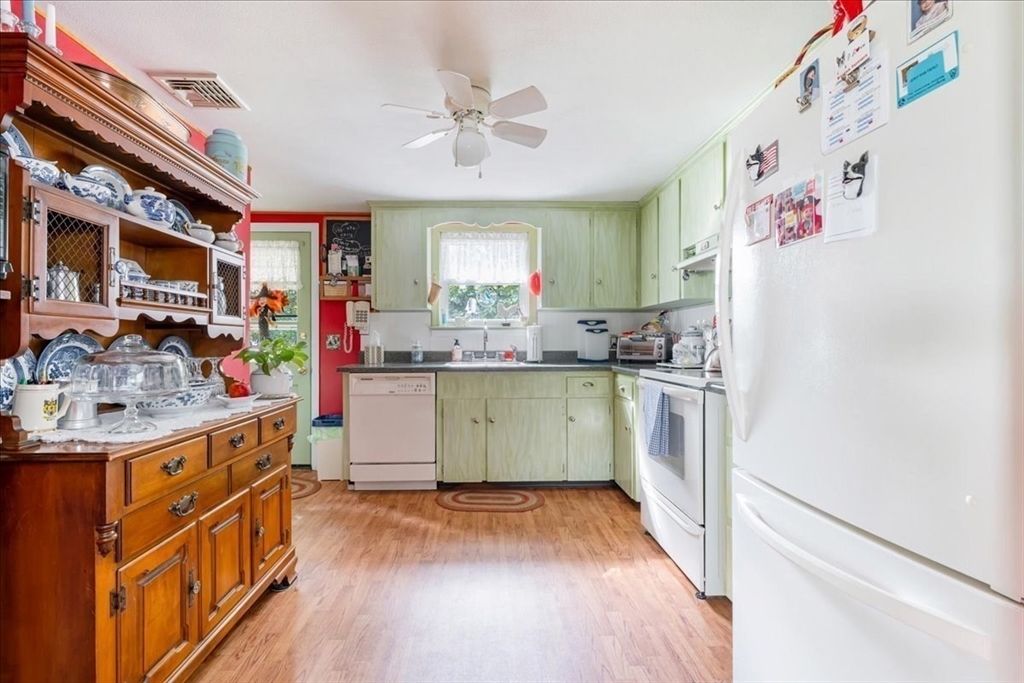 47 Beech Road Avon, MA 02322 - Photo 9 of 28 a kitchen with a sink cabinets stainless steel appliances and a window