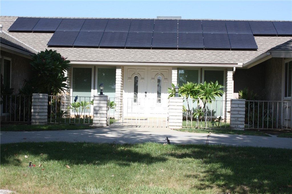 5715 North Sycamore Avenue Rialto, CA 92377 - Photo 1 of 1 a front view of a house with a yard