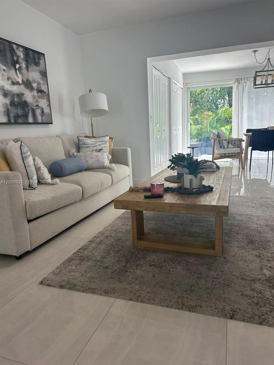 1030 Northeast 83rd Street Miami, FL 33138 - Photo 1 of 11 a living room with furniture and a large window