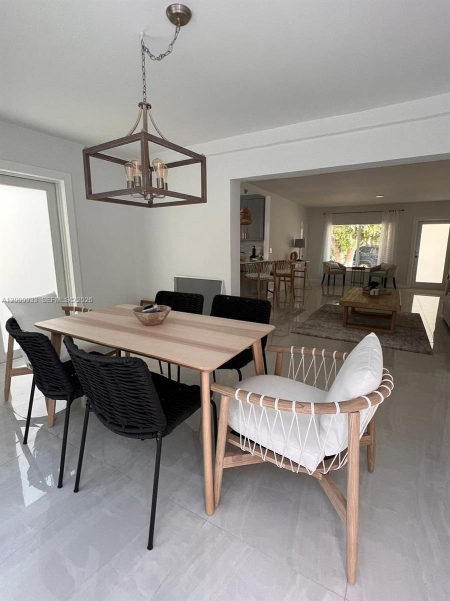 1030 Northeast 83rd Street Miami, FL 33138 - Photo 2 of 11 a view of a dining room with furniture