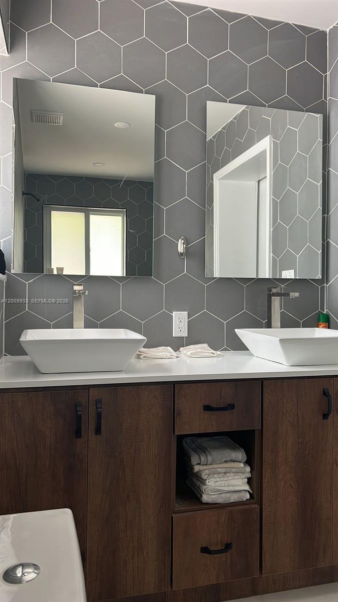 1030 Northeast 83rd Street Miami, FL 33138 - Photo 10 of 11 a bathroom with a sink and a mirror