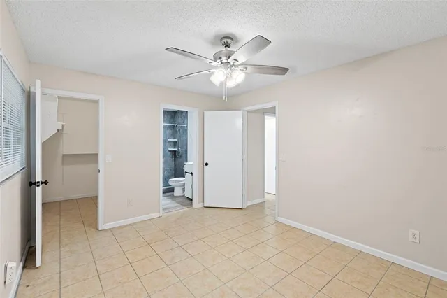a living room with furniture and floor to ceiling windows