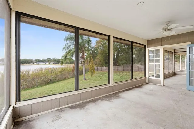 an aerial view of ocean and residential houses with outdoor space
