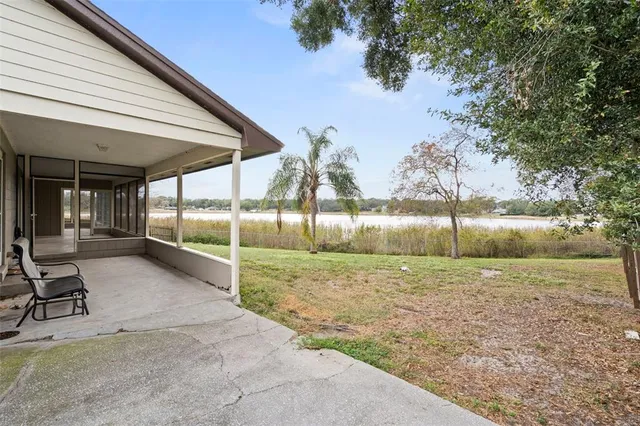a view of a lake with couches and wooden floor