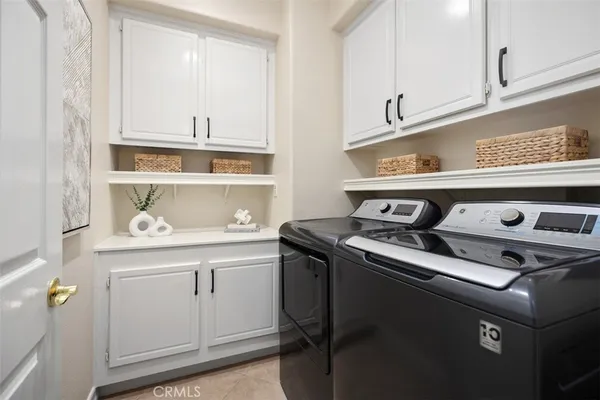 a bathroom with a granite countertop double vanity sink and mirror