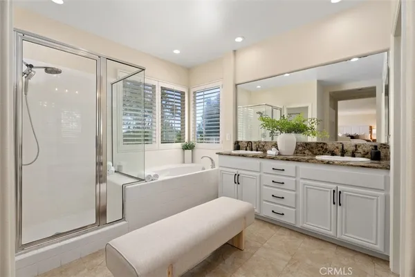 a view of a patio with table and chairs potted plants and large tree