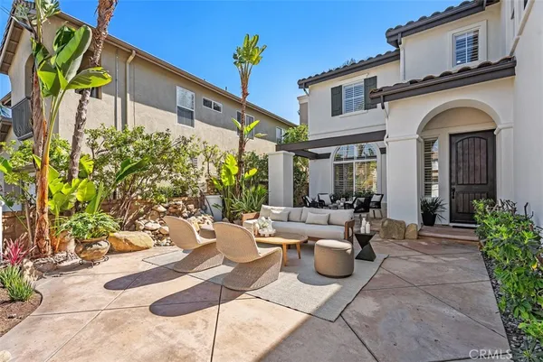 a living room with furniture and potted plant
