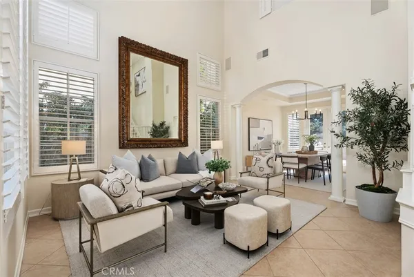 a kitchen with a dining table chairs and refrigerator