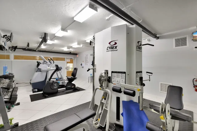 a view of swimming pool with outdoor seating and palm tree